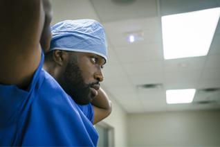 Close-up of surgeon tying surgical hat